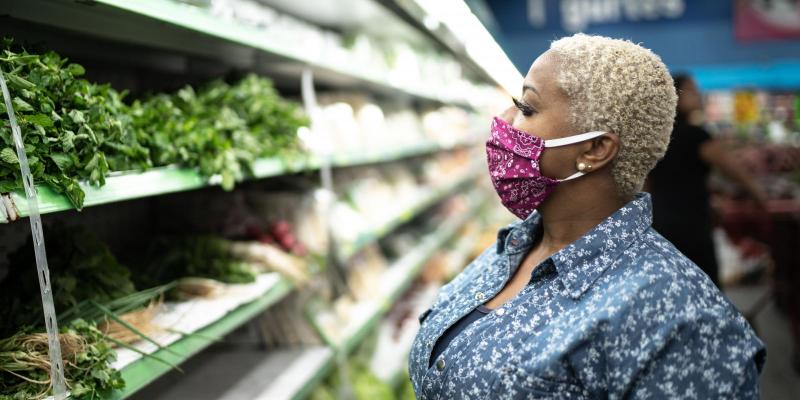 A woman wears a mask while shopping at the grocery store to exemplify Spartanburg Regional Health System's recommendations for keeping yourself and your community healthy during the COVID-19 pandemic and stopping the spread of the coronavirus.
