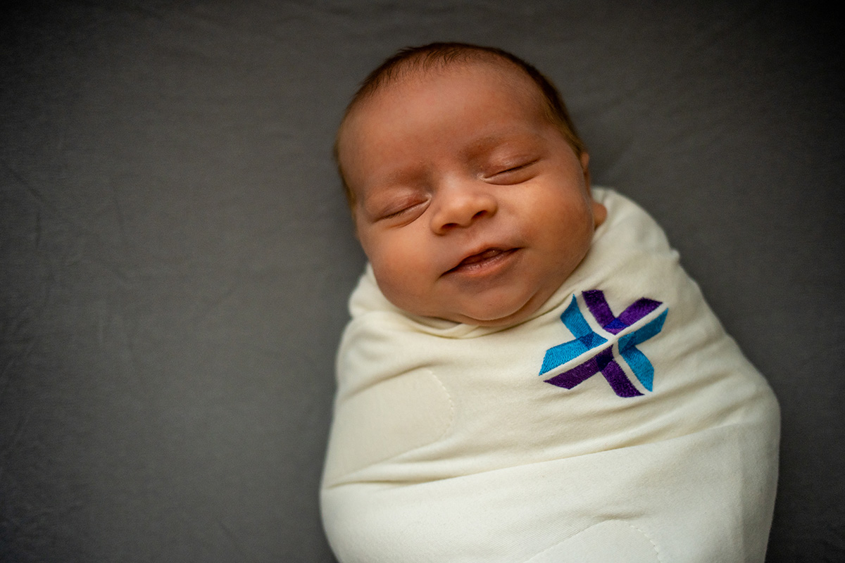 A newborn baby wrapped in a Spartanburg Regional swaddle is used to depict how to keep your baby safe while sleeping.jpg